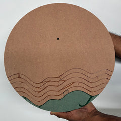 Round cardboard product with wavy design held by a person on a white background